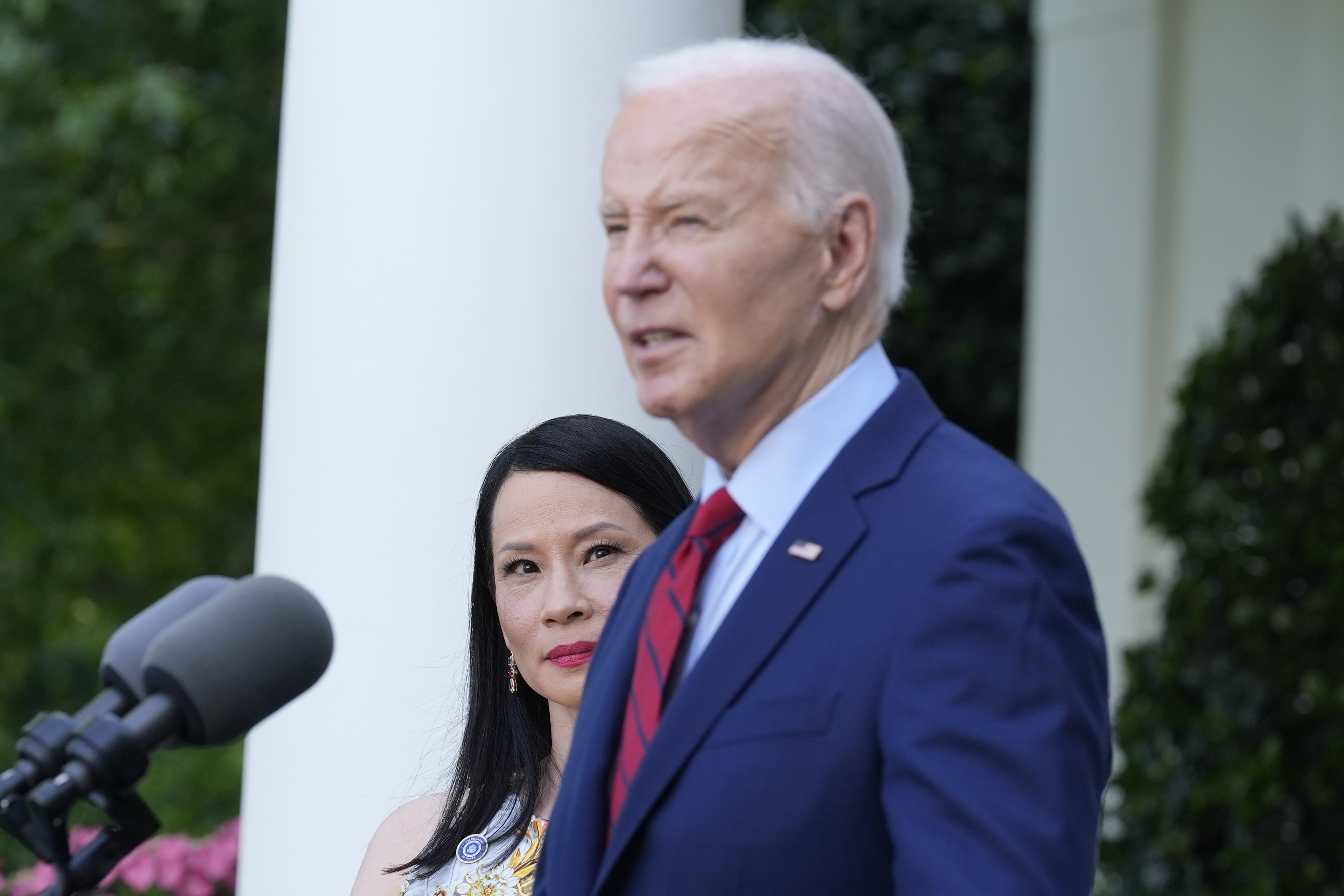 President Joe Biden speaks as actor Lucy Liu listens in the Rose Garden of the White House in Washington, Monday, May 13, 2024, during a reception celebrating Asian American, Native Hawaiian, and Pacific Islander Heritage Month. (AP Photo/Susan Walsh)